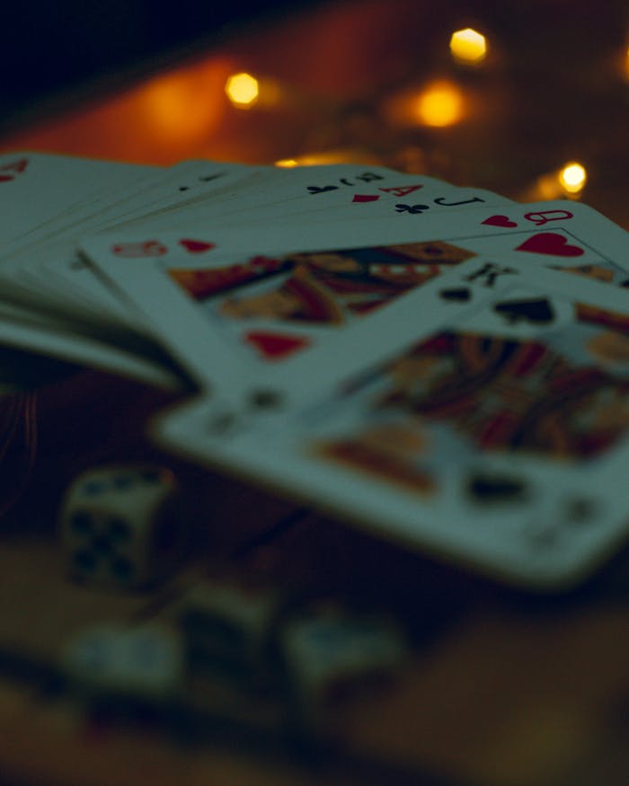 Close-up of playing cards and dice with soft bokeh lights creating a mysterious ambiance.
