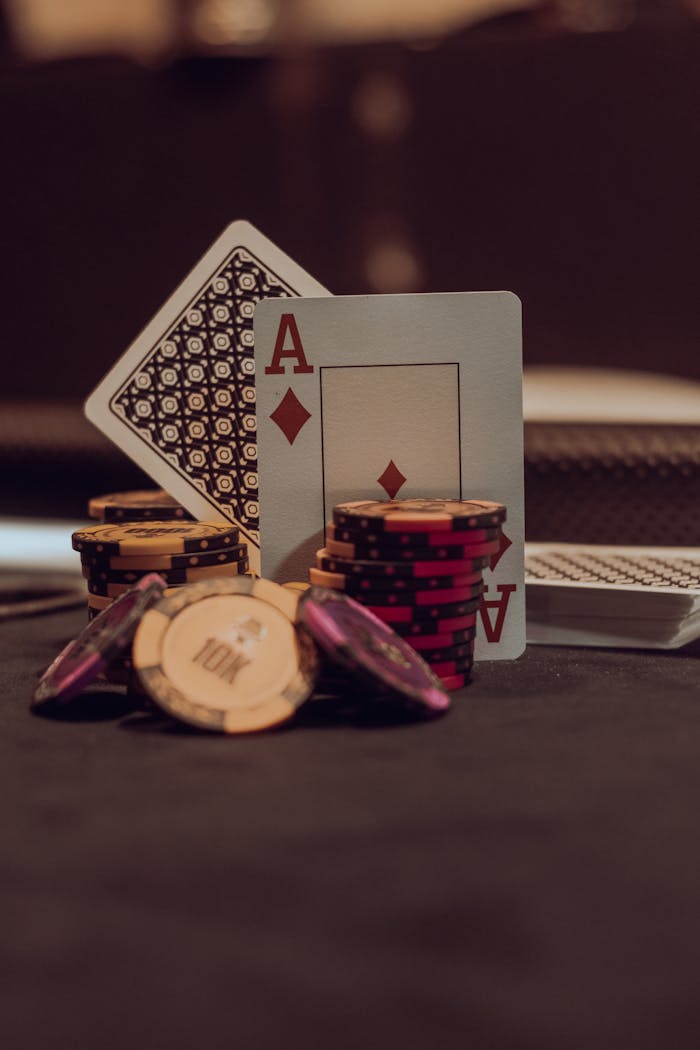 A close-up of poker chips and playing cards on a casino table, perfect for gaming themes.