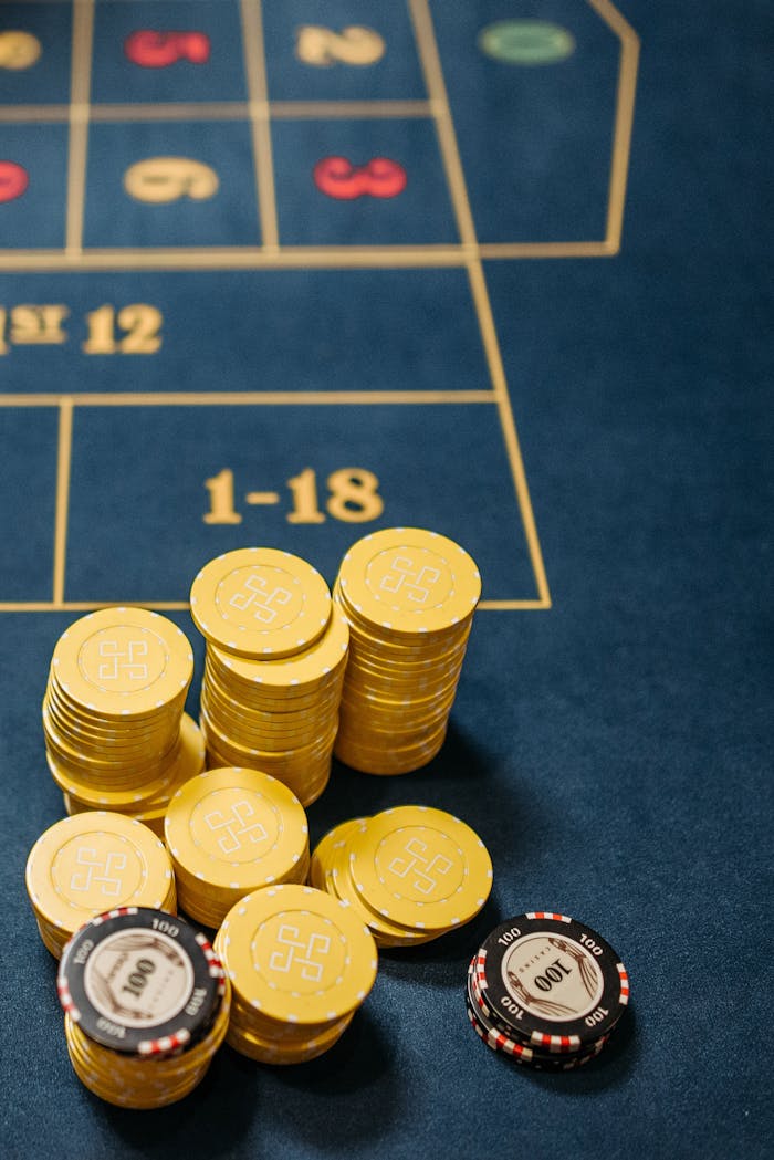 Gambling chips stacked on a roulette table, emphasizing chance and luck in gaming.