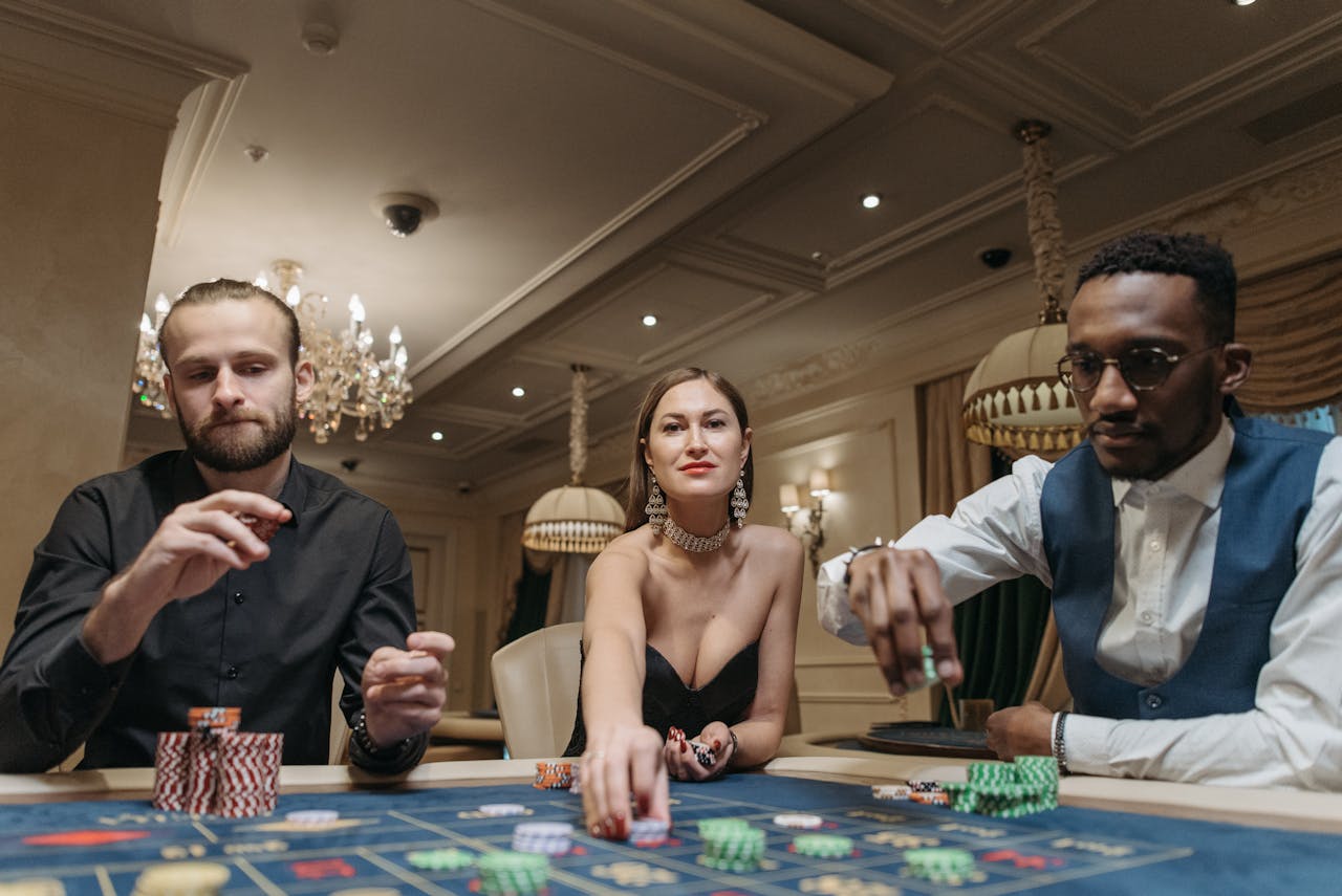 Three adults engaging in a thrilling poker game at an elegant casino.